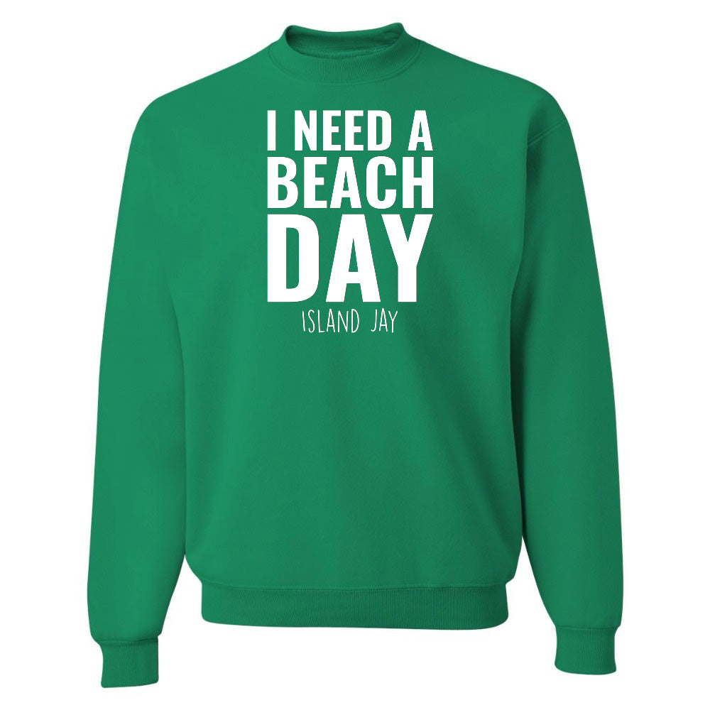 Green sweatshirt with 'I NEED A BEACH DAY' text on a white background