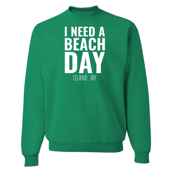 Green sweatshirt with 'I NEED A BEACH DAY' text on a white background