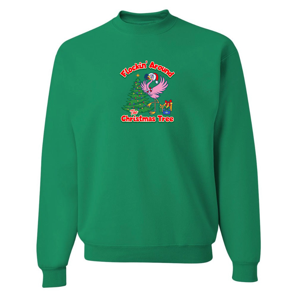 Green sweatshirt with Christmas design featuring a flamingo and tree on a white background