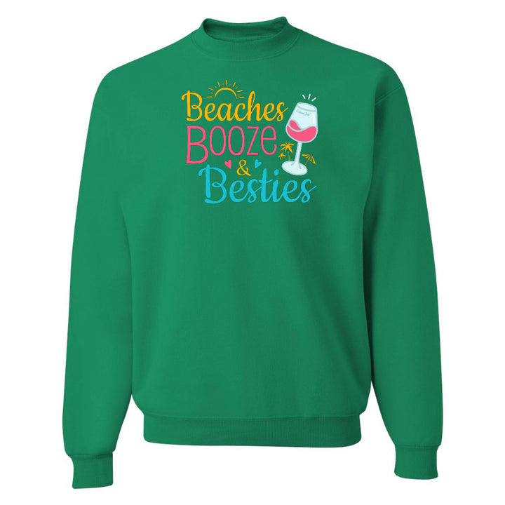 Green sweatshirt with 'Beaches Booze & Besties' text and wine glass graphic on a white background
