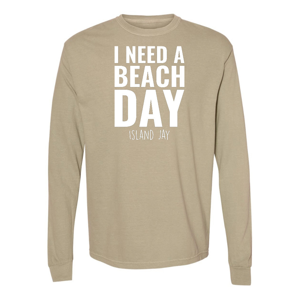 Beige long-sleeve shirt with 'I NEED A BEACH DAY' text on a white background