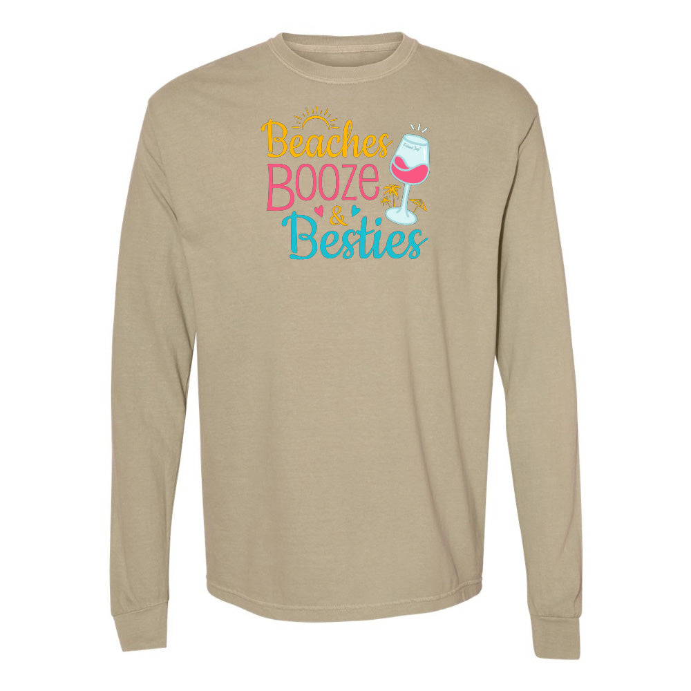 Beige long-sleeve shirt with 'Beaches, Booze & Besties' text and wine glass graphic on a white background