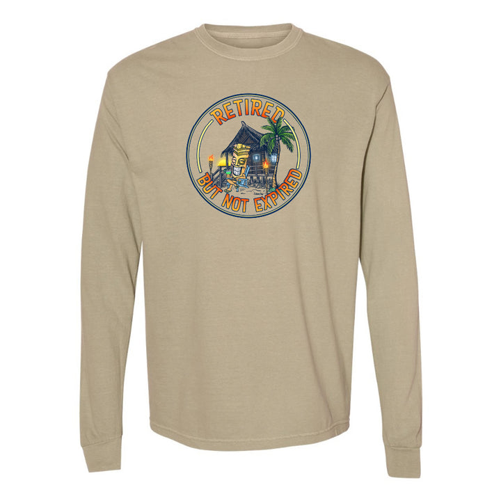 Beige long-sleeve shirt with a tropical graphic and 'Retired but not expired' text on a white background