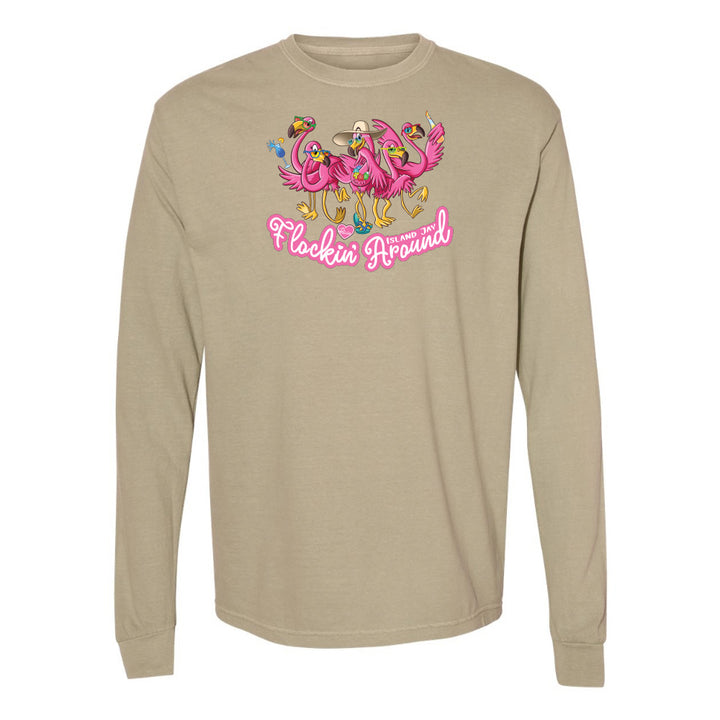 Beige long-sleeve shirt with pink flamingo design and text on a white background