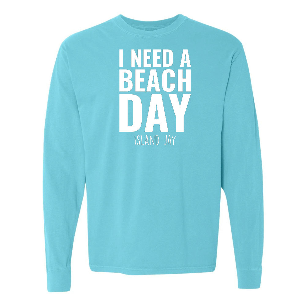 Light blue long-sleeve shirt with 'I NEED A BEACH DAY' text on a white background
