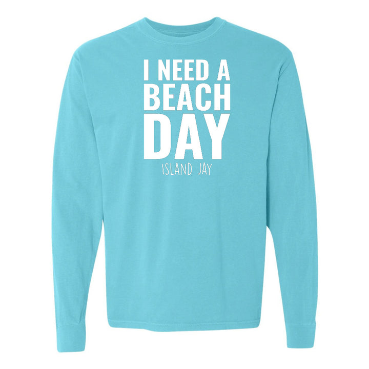 Light blue long-sleeve shirt with 'I NEED A BEACH DAY' text on a white background