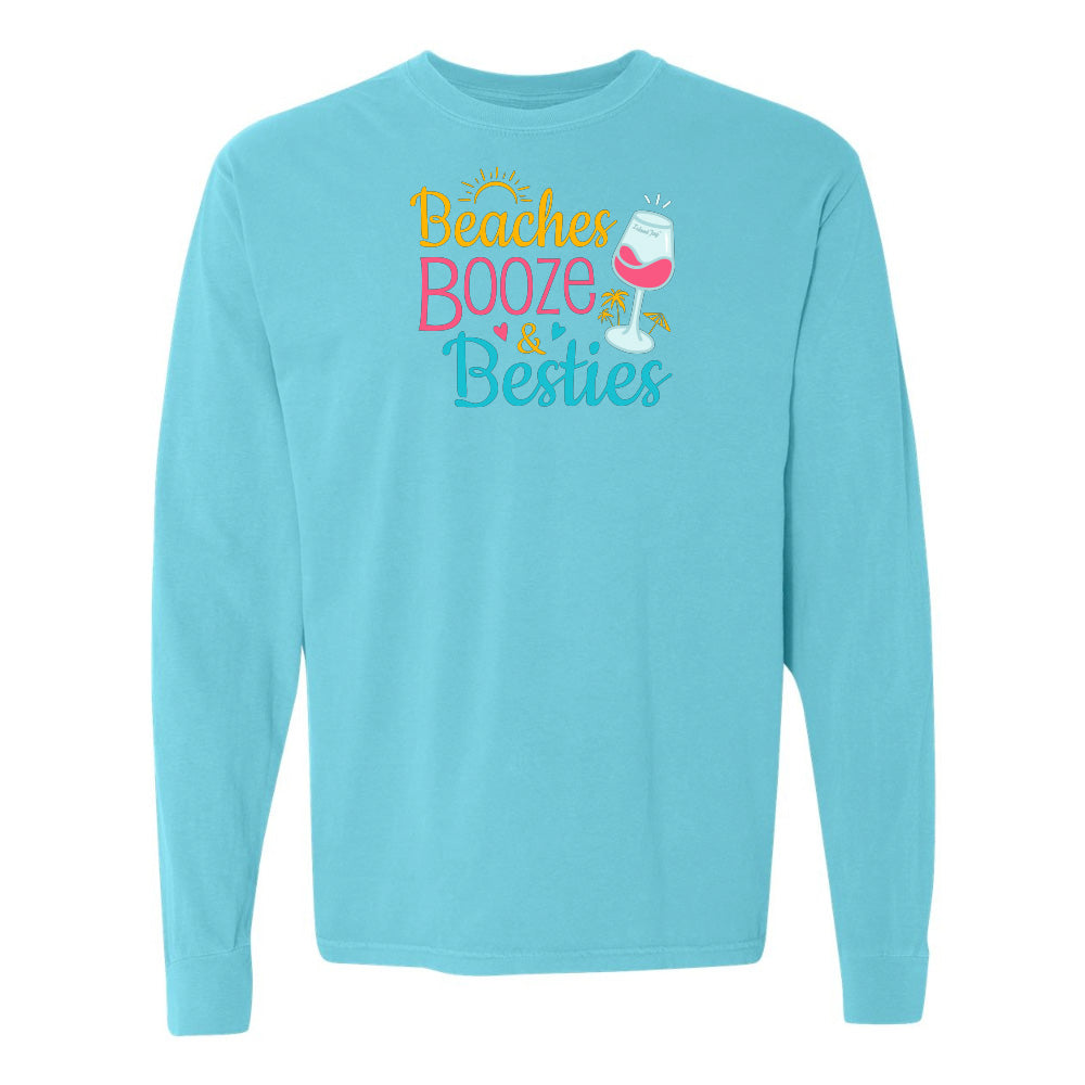 Light blue long-sleeve shirt with 'Beaches Booze & Besties' text and wine glass graphic on a white background