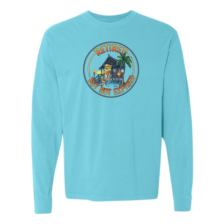 Light blue long-sleeve shirt with a tropical design and text on a white background