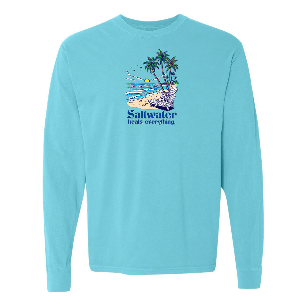 Light blue long-sleeve shirt with a beach graphic and 'Saltwater heals everything' text on a white background.