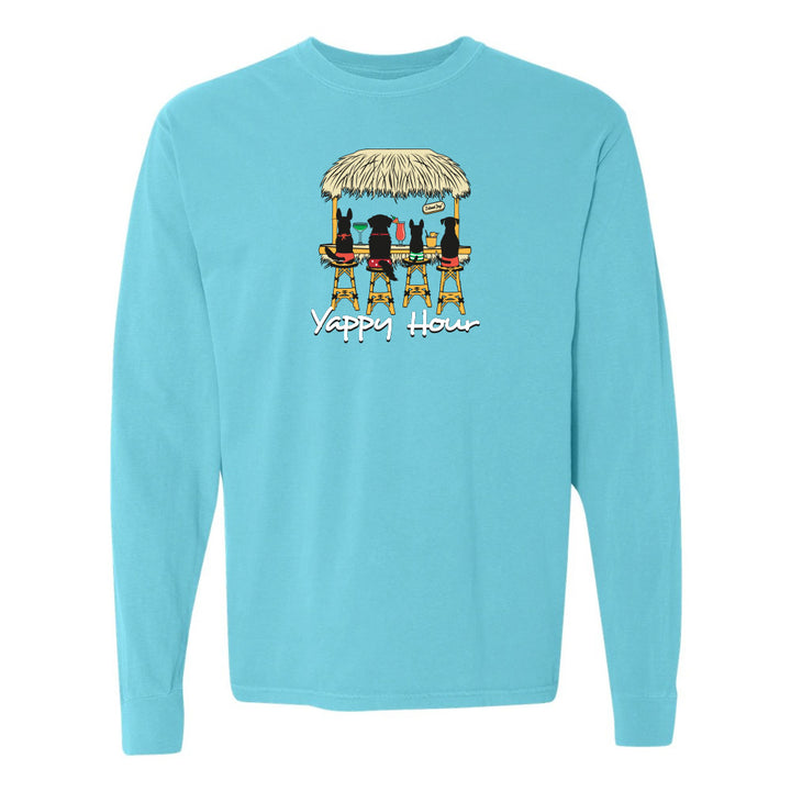 Light blue long-sleeve shirt with a graphic of dogs at a beach hut and 'Yappy Hour' text.