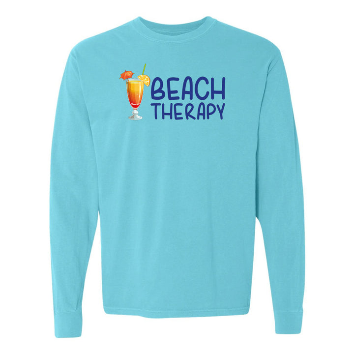 Light blue long-sleeve shirt with 'Beach Therapy' text and cocktail graphic on a white background