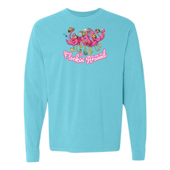 Light blue long-sleeve shirt with pink flamingo design and text on a white background