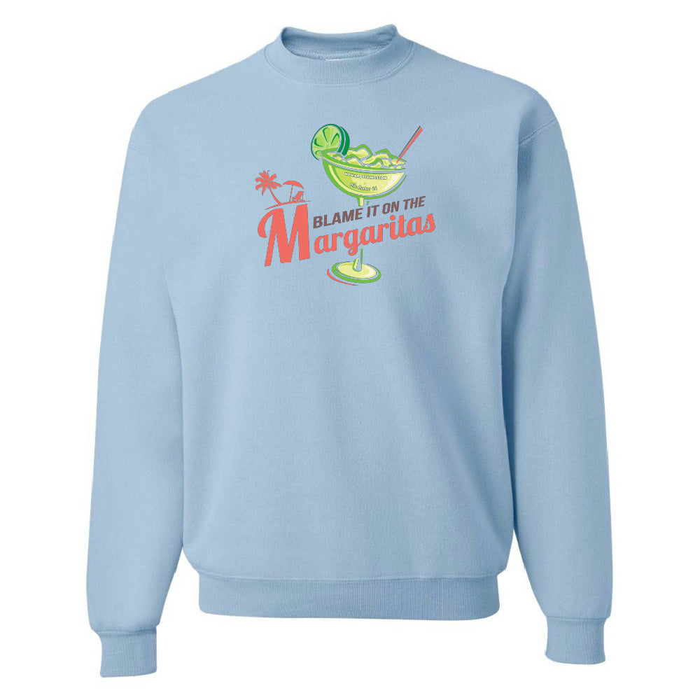 Light blue sweatshirt with a graphic of a margarita and text 'Blame it on the Margaritas' on a white background