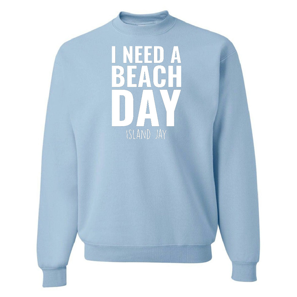 Light blue sweatshirt with 'I NEED A BEACH DAY' text on a white background