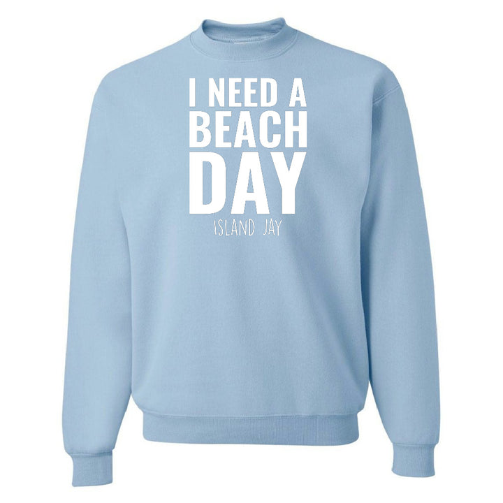 Light blue sweatshirt with 'I NEED A BEACH DAY' text on a white background