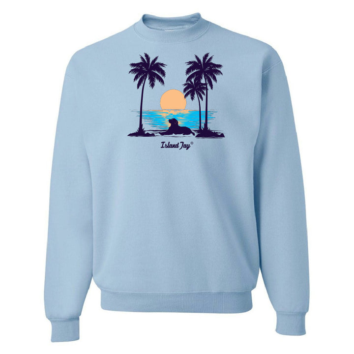 Light blue sweatshirt with a tropical graphic of palm trees and a sunset on a white background