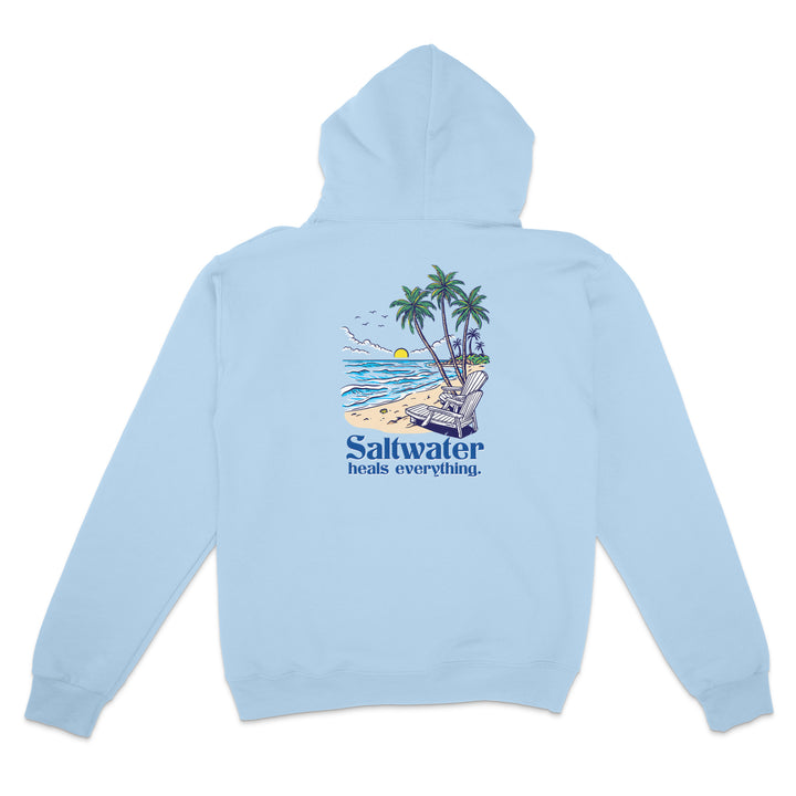 Light blue hoodie with a beach graphic and 'Saltwater heals everything' text on the back, against a white background.