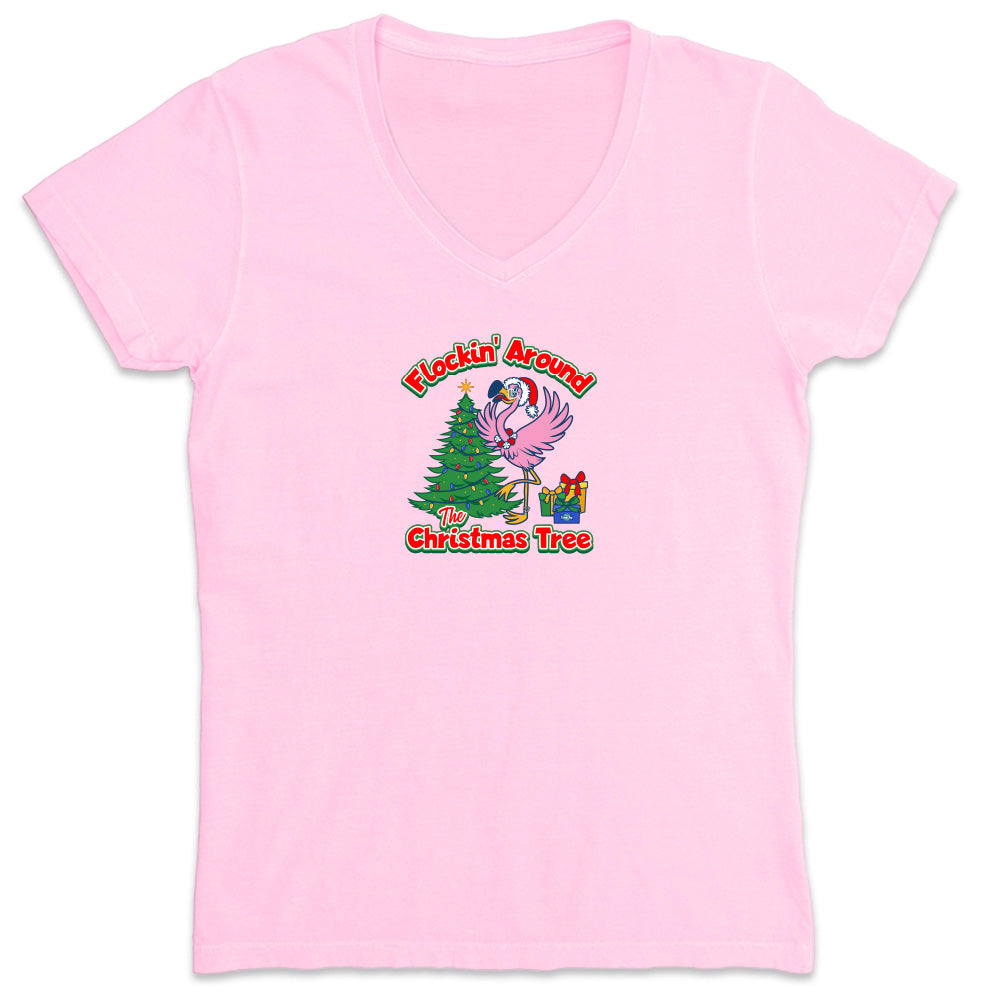 Pink t-shirt with Christmas-themed design featuring a flamingo and tree on a white background