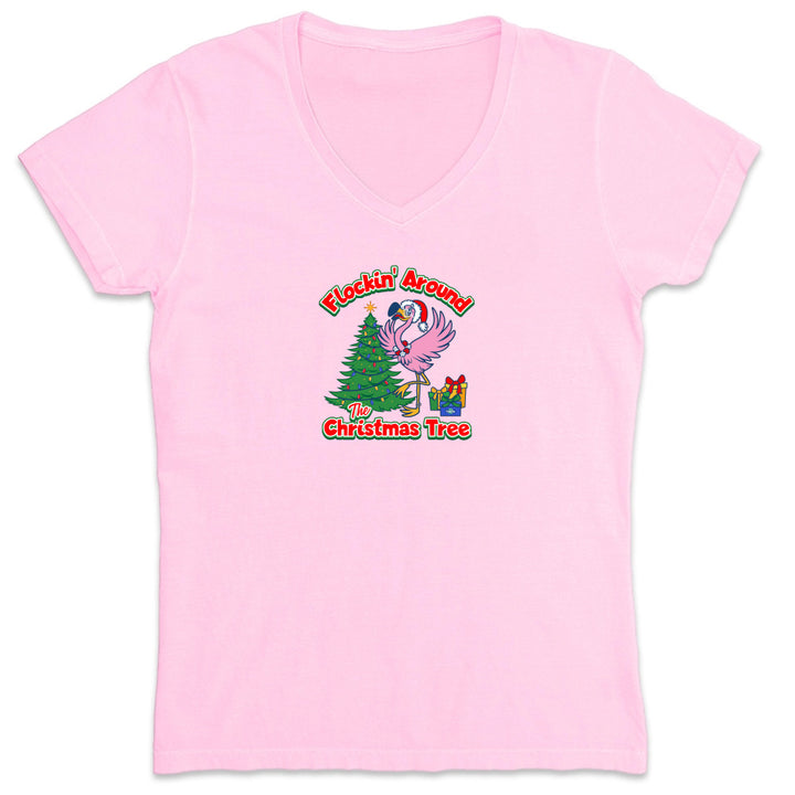 Pink t-shirt with Christmas-themed design featuring a flamingo and tree on a white background