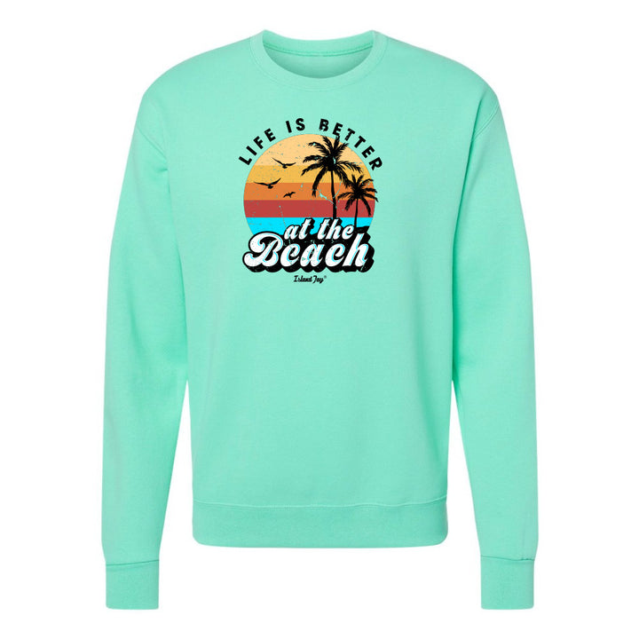Mint green sweatshirt with 'Life is Better at the Beach' graphic on a white background