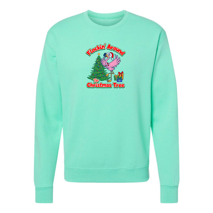 Mint green sweatshirt with Christmas design featuring a flamingo and tree on a white background