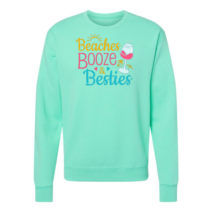 Mint green sweatshirt with 'Beaches Booze & Besties' text and graphics on a white background