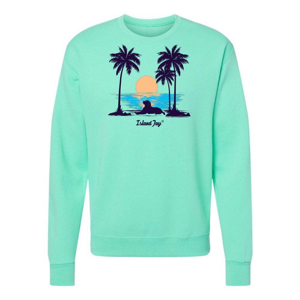 Mint green sweatshirt with a tropical graphic of palm trees and a sunset on a white background