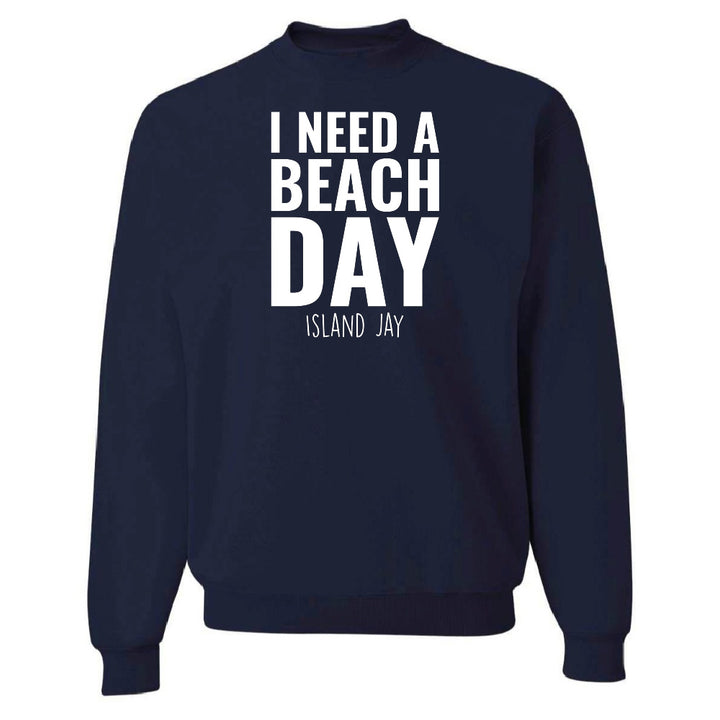 Navy blue sweatshirt with 'I NEED A BEACH DAY' text on a white background