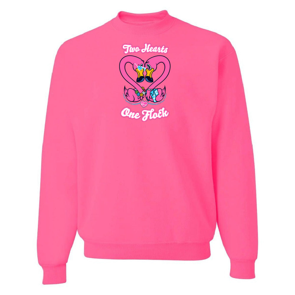 Pink sweatshirt with a heart design and text on a white background