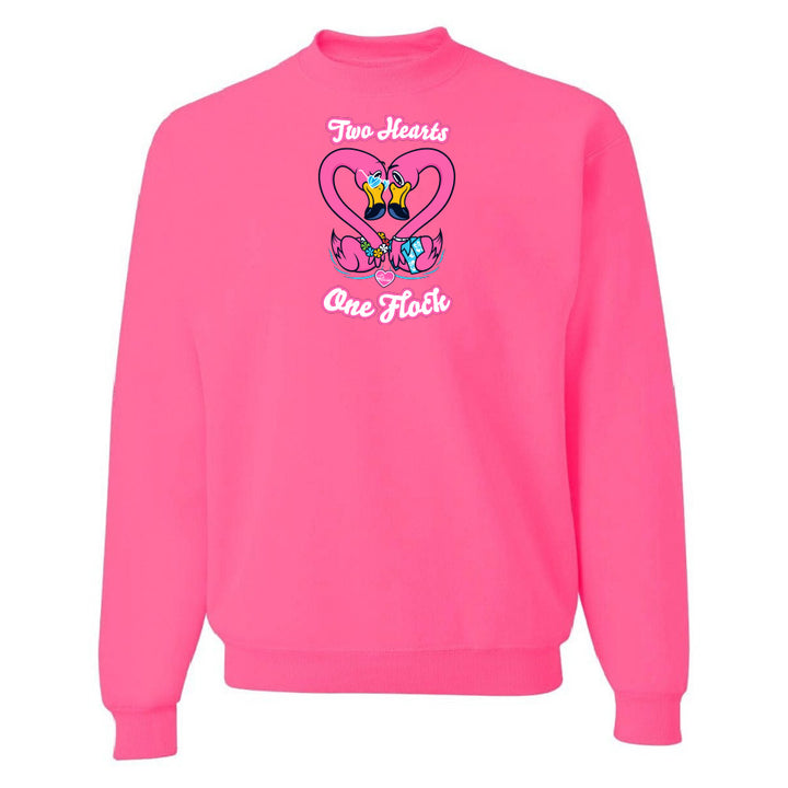 Pink sweatshirt with a heart design and text on a white background