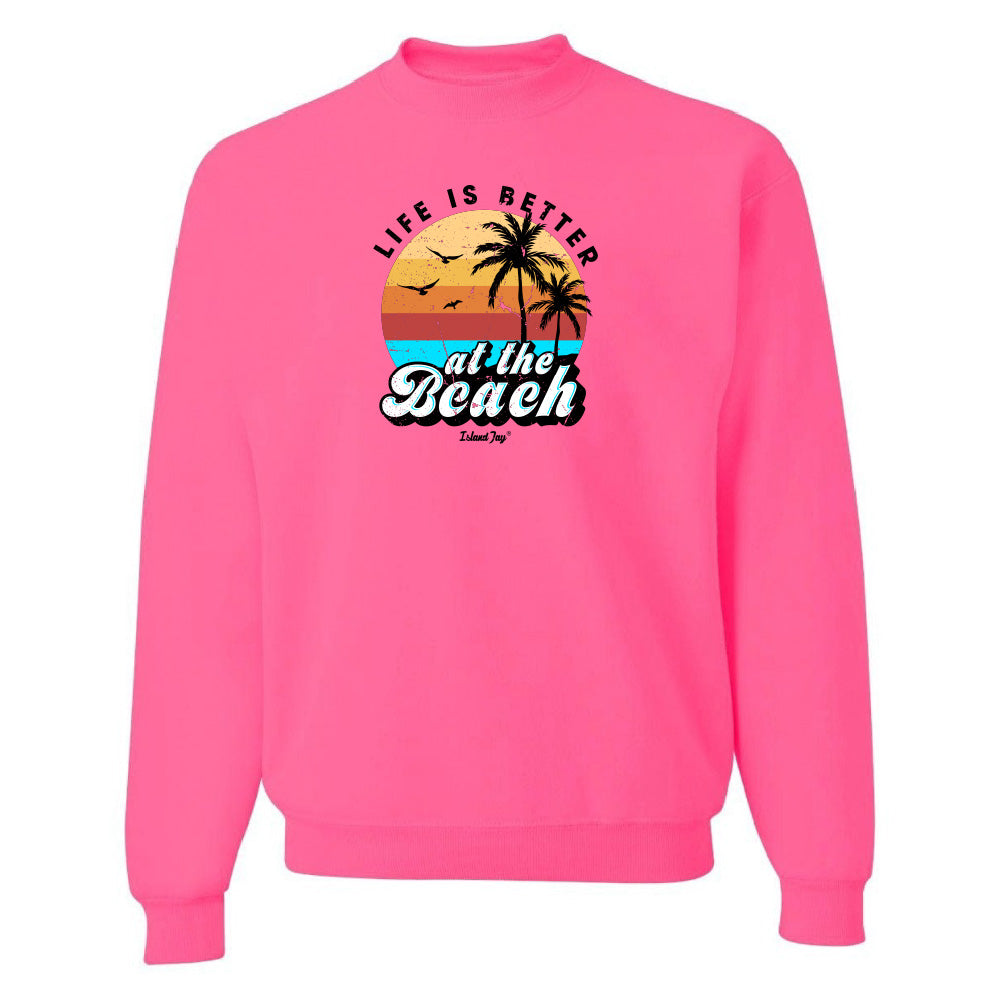 Pink sweatshirt with 'Life is Better at the Beach' graphic on a white background