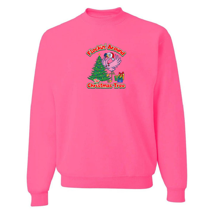 Pink sweatshirt with Christmas design featuring a flamingo and tree on a white background