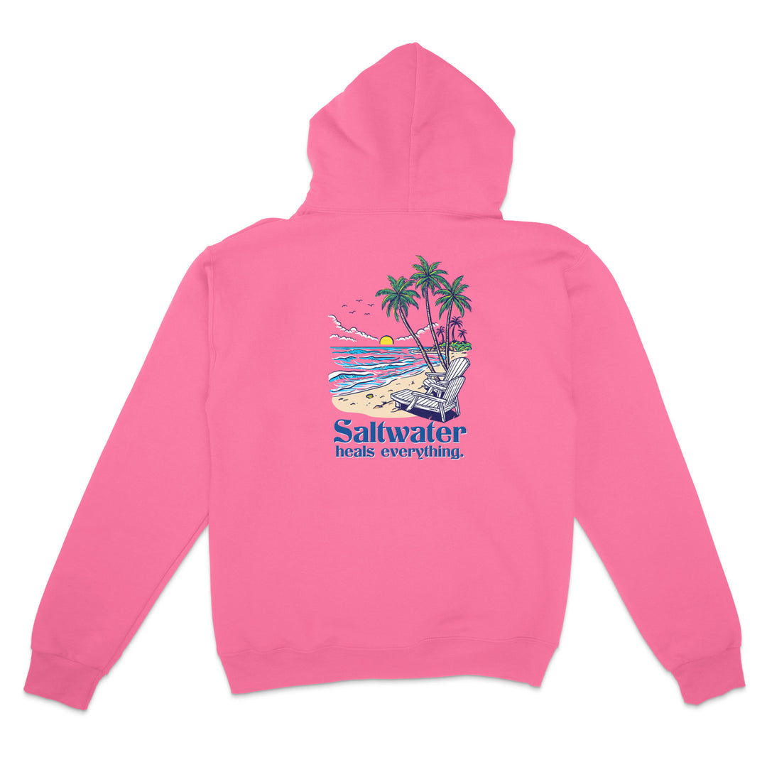 Pink hoodie with a beach graphic and 'Saltwater heals everything' text on the back, against a white background.