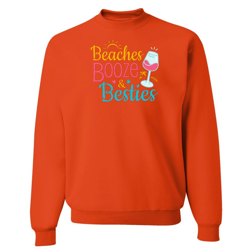 Orange sweatshirt with 'Beaches Booze & Besties' text and wine glass graphic on a white background