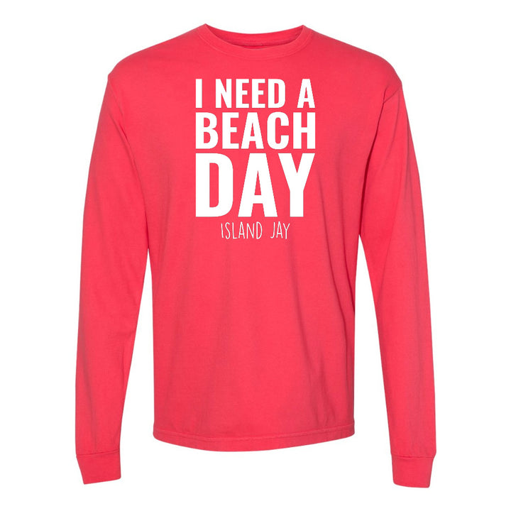 Red long-sleeve shirt with 'I NEED A BEACH DAY' text on a white background