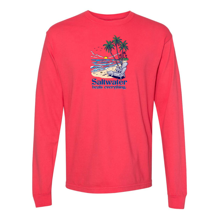 Red long-sleeve shirt with a beach graphic and 'Saltwater heals everything' text on a white background