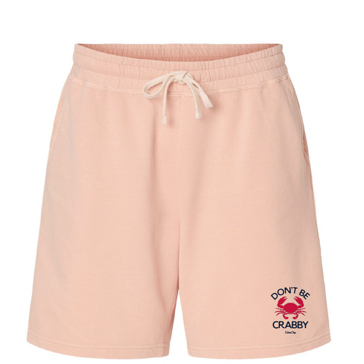 Pink shorts with a crab graphic and text on a white background