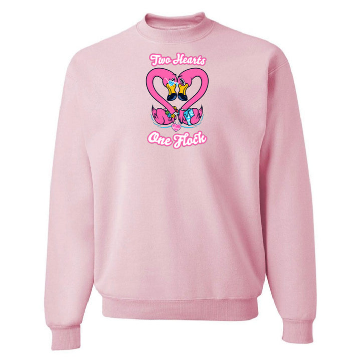 Pink sweatshirt with a heart design and text on a white background