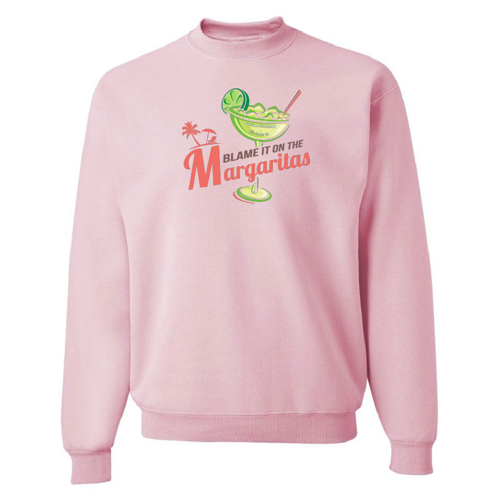 Pink sweatshirt with a graphic design and text on a white background