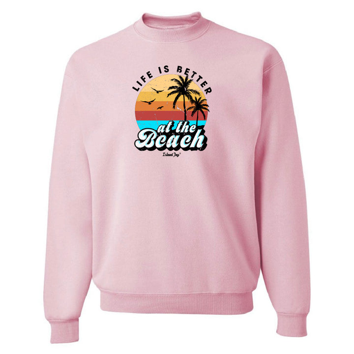 Pink sweatshirt with 'Life is Better at the Beach' graphic on a white background