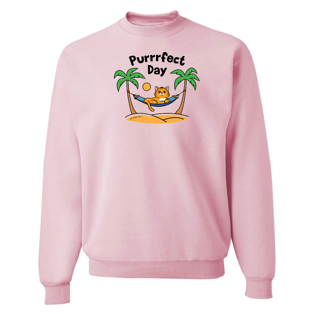 Pink sweatshirt with a 'Purrfect Day' graphic featuring a cat, palm trees, and a hammock on a white background.
