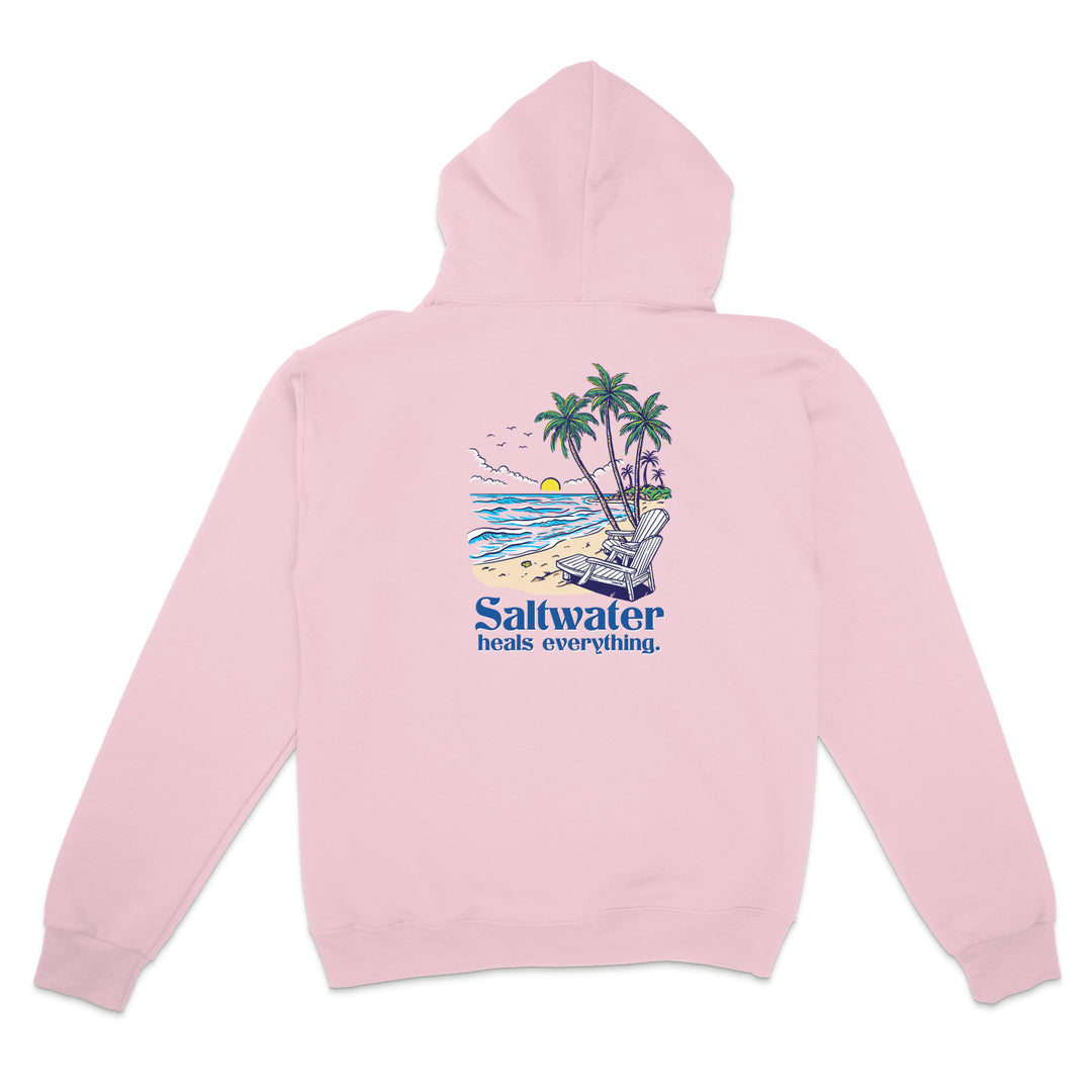 Pink hoodie with a beach graphic and 'Saltwater heals everything' text on a white background