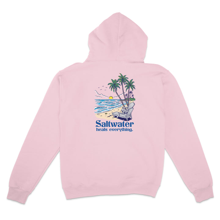 Pink hoodie with a beach graphic and 'Saltwater heals everything' text on a white background