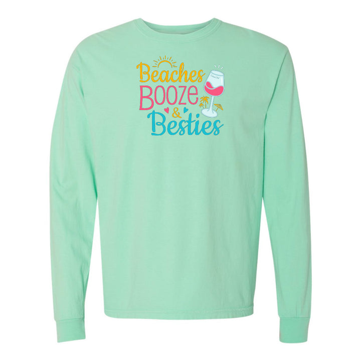 Mint green long-sleeve shirt with 'Beaches Booze & Besties' text and graphics on a white background