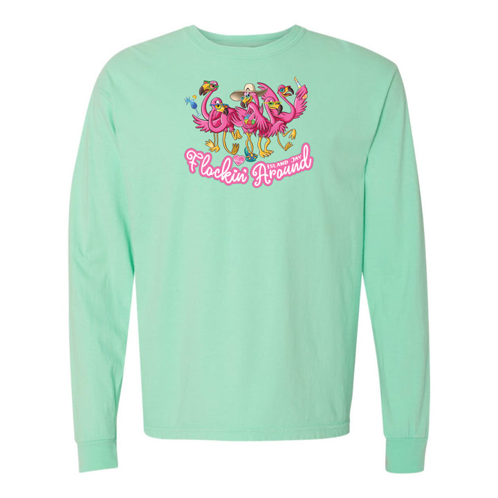 Mint green long-sleeve shirt with flamingo design and text on a white background