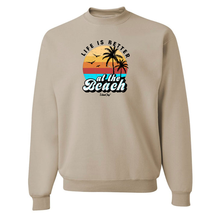 Beige sweatshirt with 'Life is Better at the Beach' graphic design on a white background