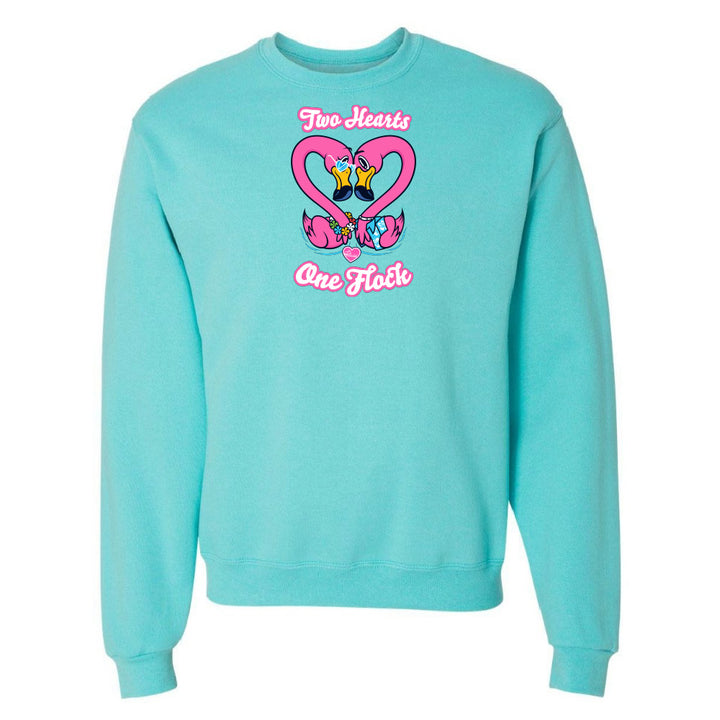 Turquoise sweatshirt with a heart design and text on a white background