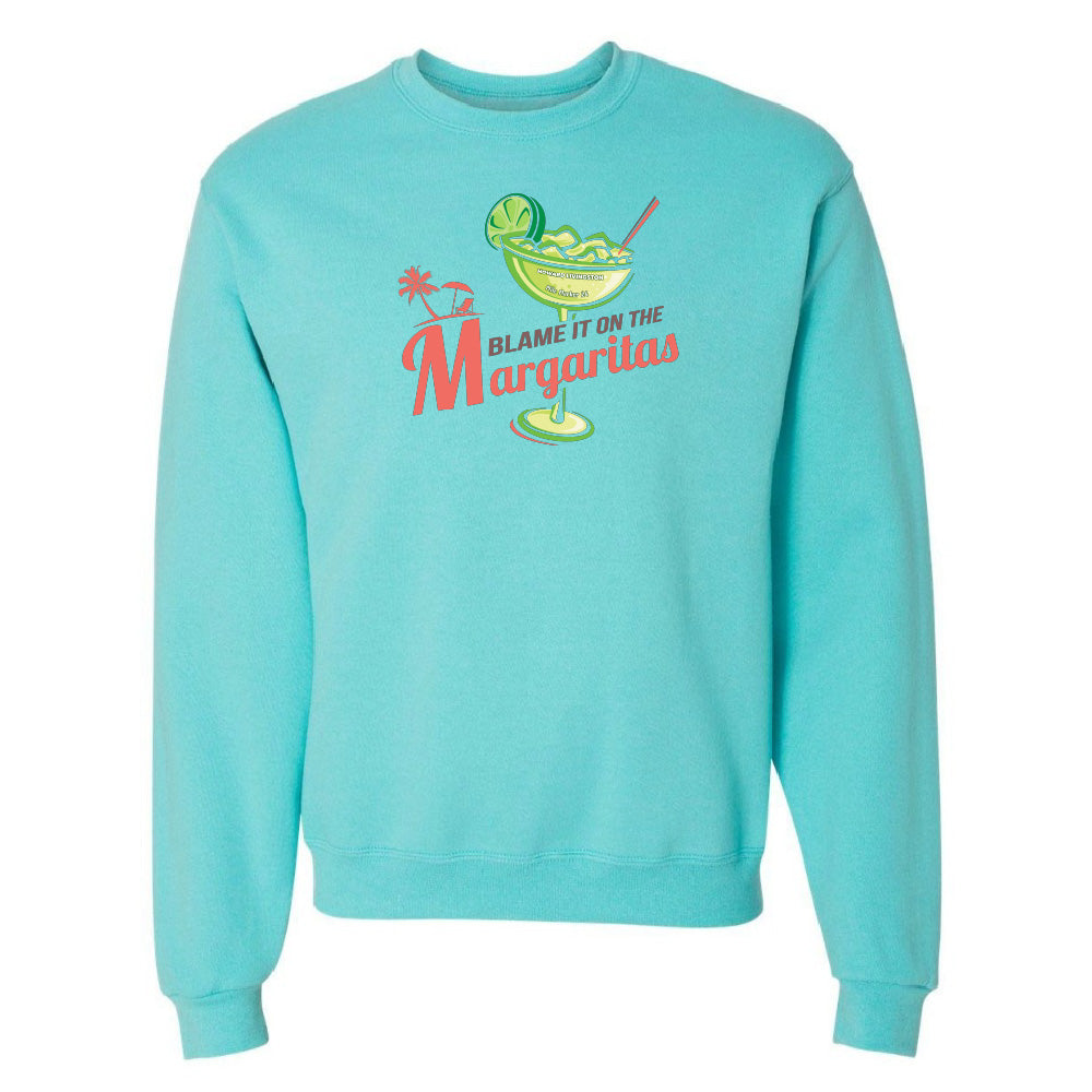 Turquoise sweatshirt with a graphic of a margarita and text 'Blame it on the Margaritas' on a white background