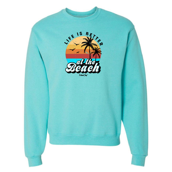 Turquoise sweatshirt with 'Life is Better at the Beach' graphic on a white background