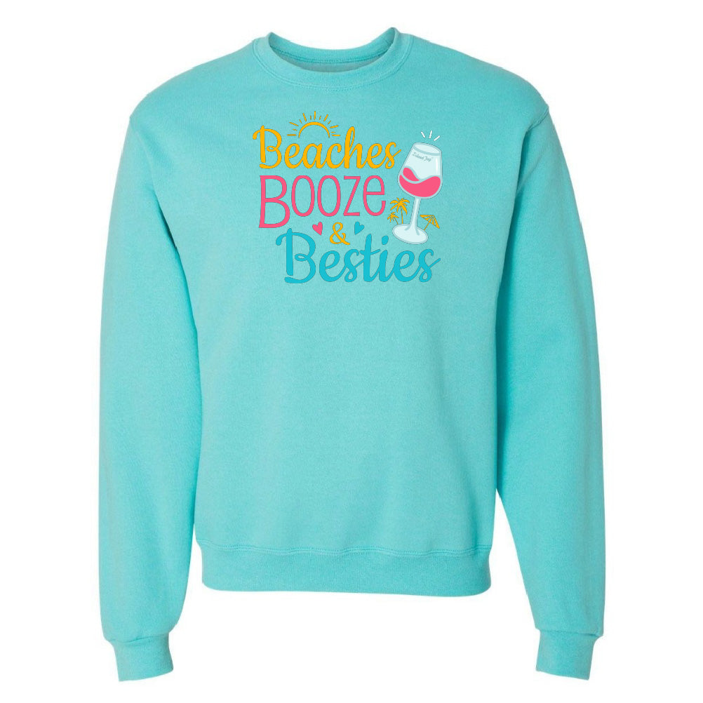 Turquoise sweatshirt with 'Beaches Booze & Besties' text and wine glass graphic on a white background